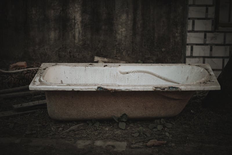 High Angle Shot of an Old Broken Bathtub Thrown in an Abandoned