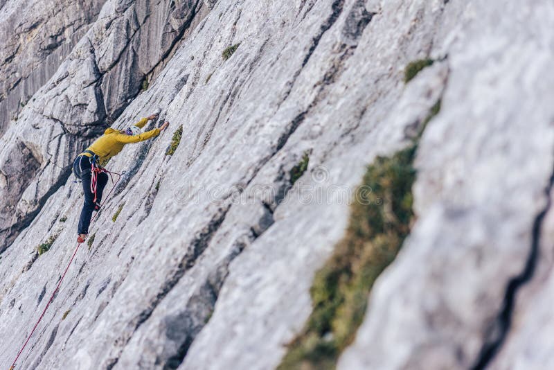 High angle shot of a person climbing a rock in the Alps in Austria - overcoming challenges concept