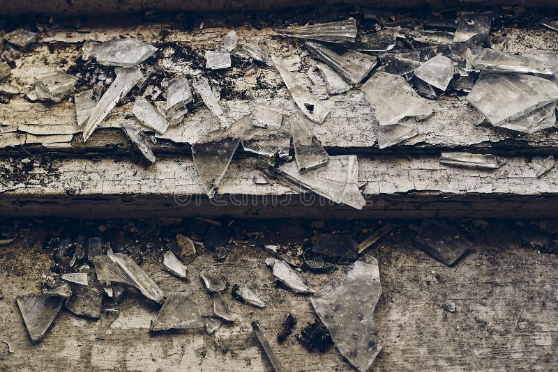 High angle shot of shattered glass scattered over the old wooden stair