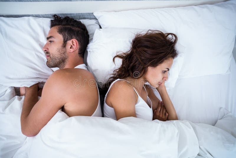 High angle view of angry couple on bed stock photo