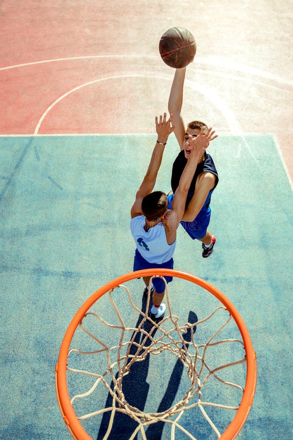 High Angle View of Basketball Player Dunking Basketball in Hoop Stock