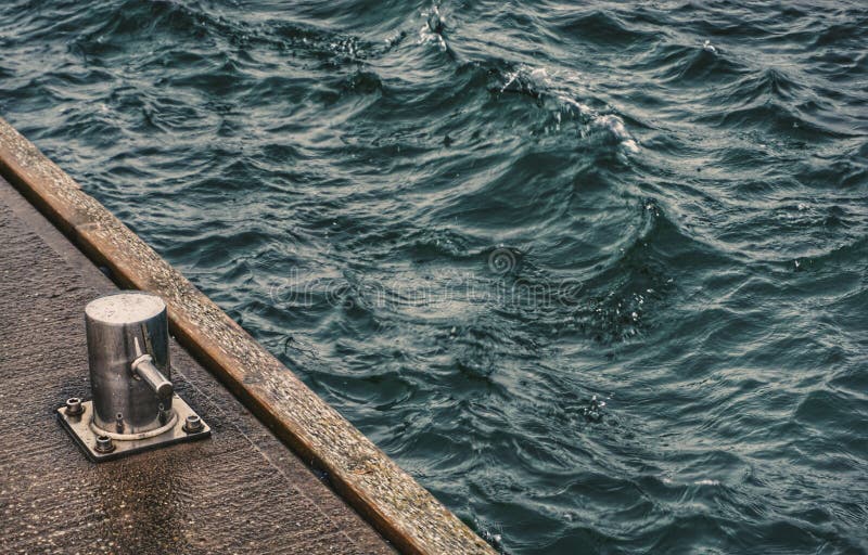 High angle view of bollard on bridge at the sea royalty free stock images