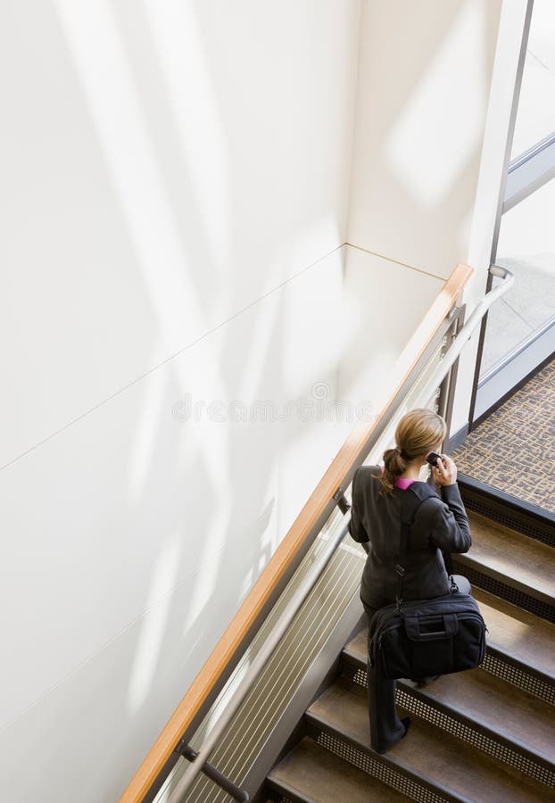 High angle view of businesswoman ascending stairs