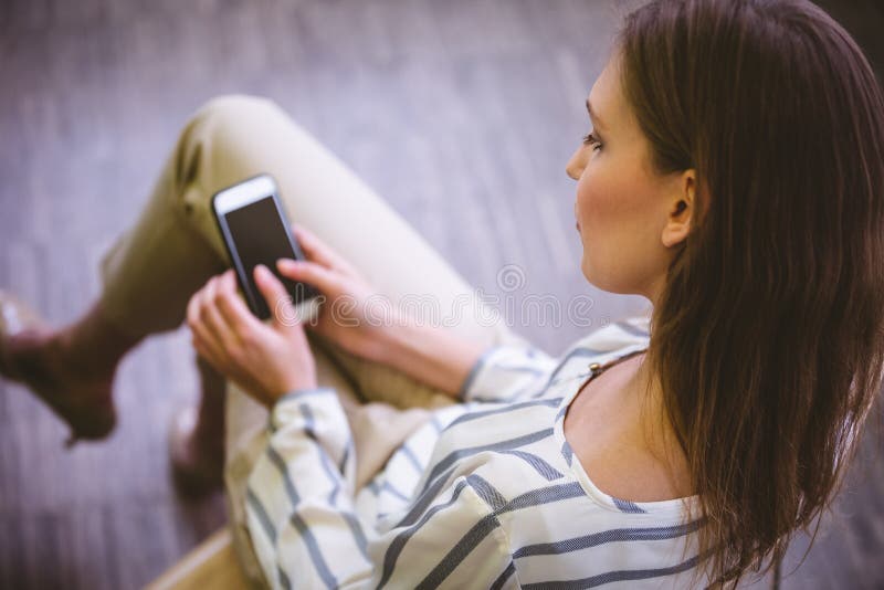 High angle view of businesswoman using mobile phone at office stock photos