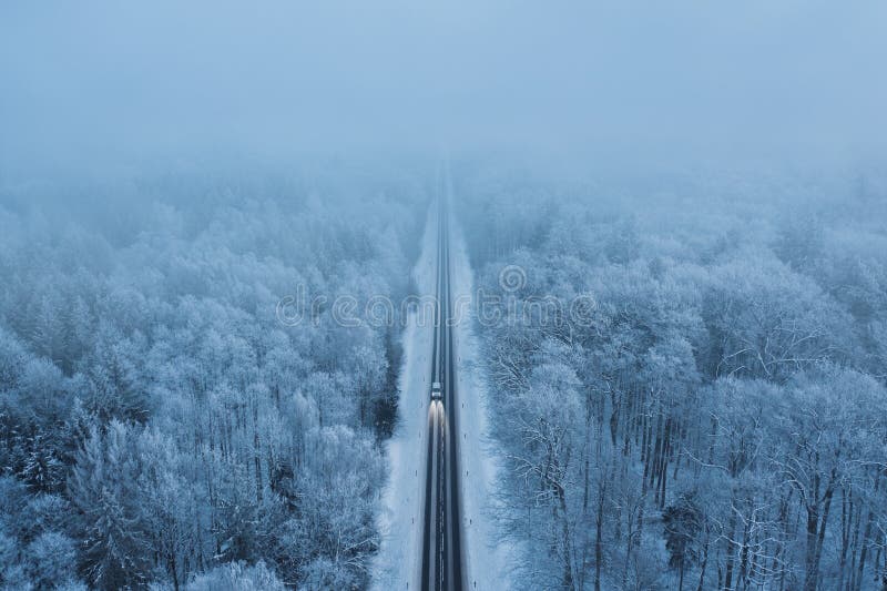 High angle view of a car on the road trough the winter forest royalty free stock image