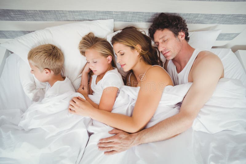 High angle view of family sleeping stock image