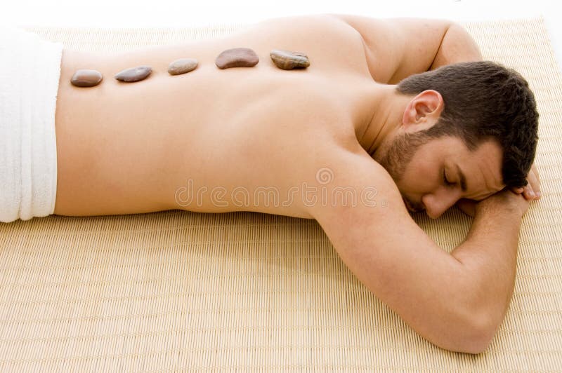 High angle view of man lying down on mat at spa