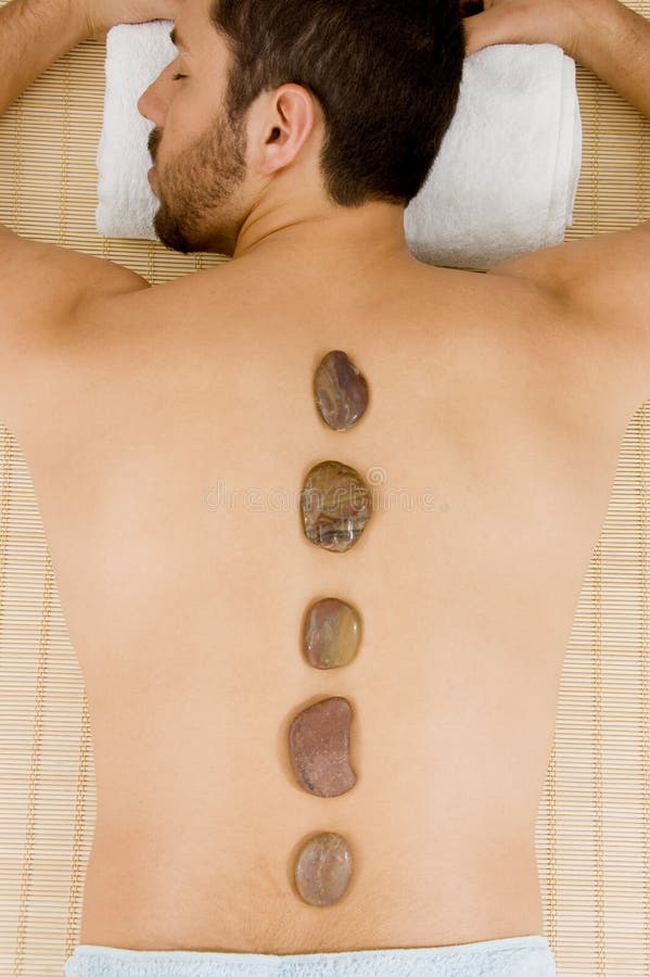 High angle view of man receiving hot stone massage