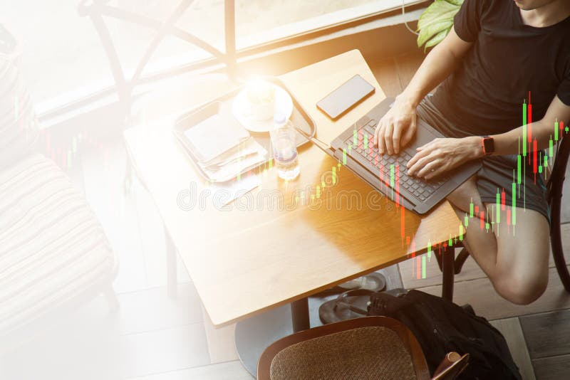 High angle view part of a man using laptop on desk at coffee cafe next a window stock photography