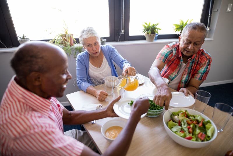 High angle view of senior people having salad and juice royalty free stock image