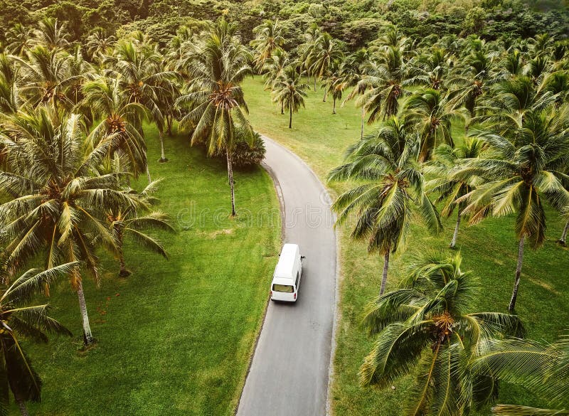 High angle view of a small camper driving through tropical landscape stock photography