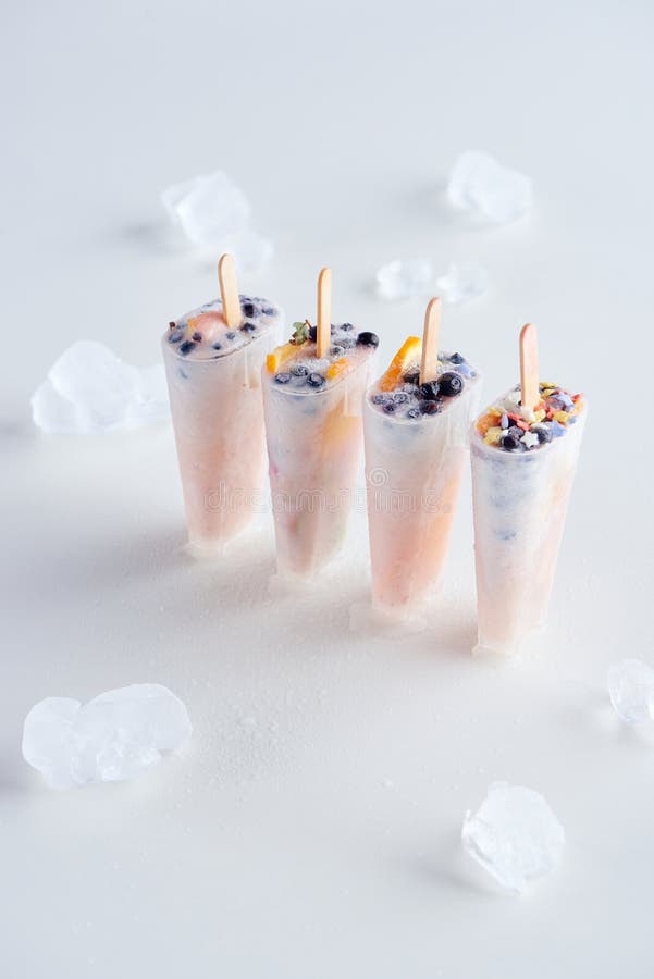high angle view of sweet homemade popsicles with fruits and berries and ice cubes stock photo high angle view of sweet homemade popsicles with fruits and berries and ice cubes stock photo