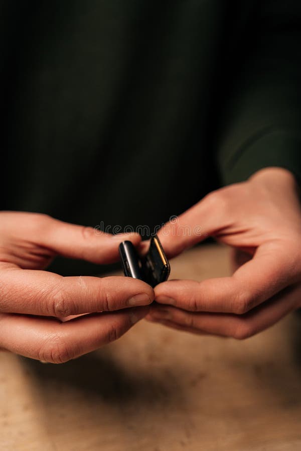 High-angle view of unrecognizable repairman preparation to replacement smartwatch battery, showing precision workmanship stock images