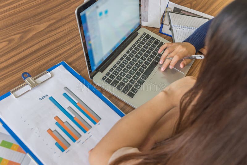 High angle view of businesswomen using laptop while having discussion stock photo High angle view of businesswomen using laptop while having discussion stock photo