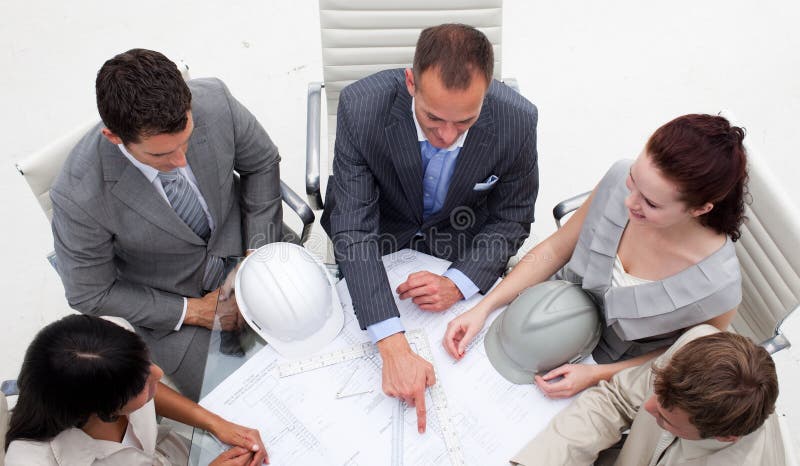 High angle of young architects working with plans stock images