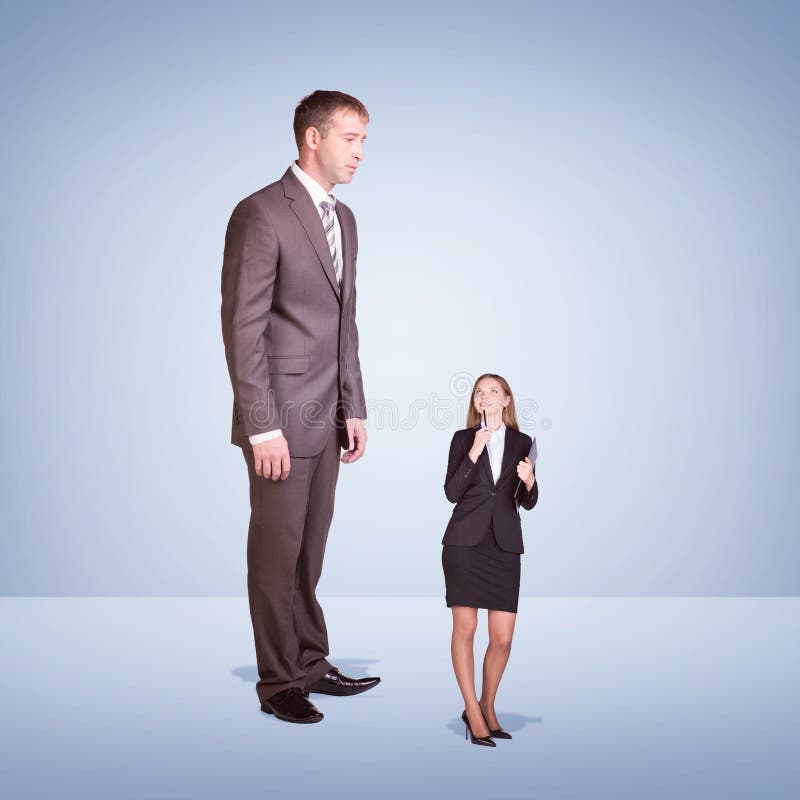 High Businessman Looking Down at Little Woman with Stock Photo - Image ...