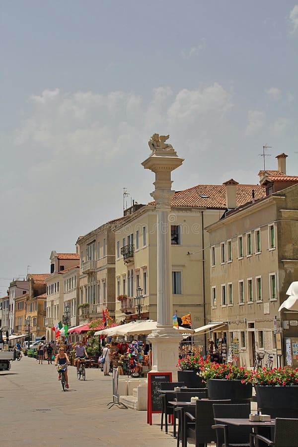 column with a sculpture of a small lion, view of the center of the Italian city of Chioggia, a symbol of the city of Chioggia stock image