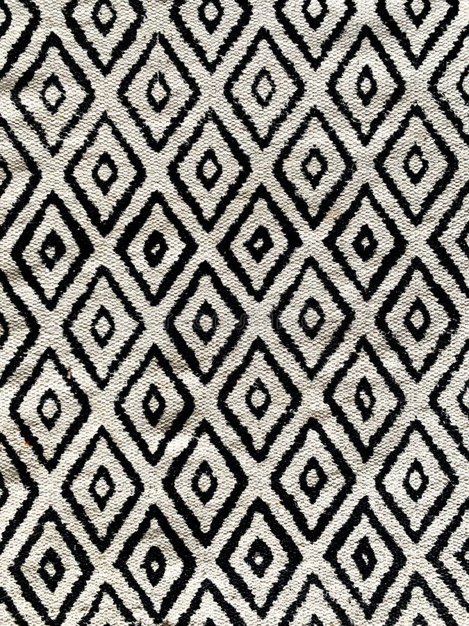 High contrast diamond pattern black and white throw rug royalty free stock photography