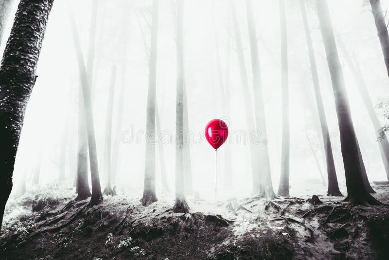 High contrast image of a red balloon in the woods stock photo High contrast image of a red balloon in the woods stock photo