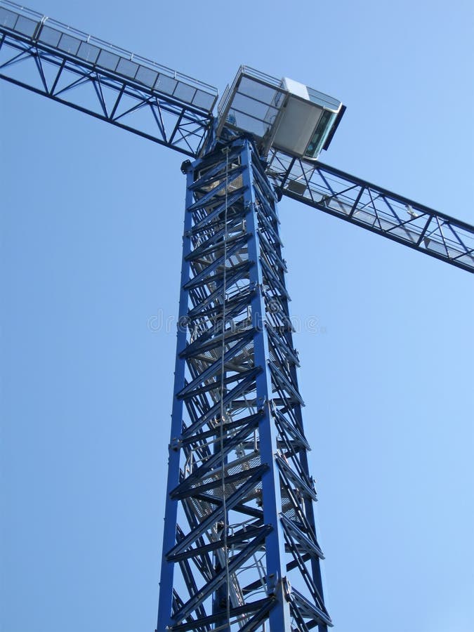 High crane silhouette on bright blue sky