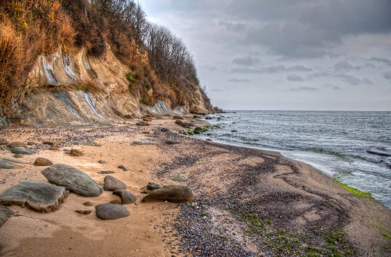 View of a rocky bay with dramatic cloudscape in the sky. Image captured at Byala Bay, Bulgaria. High dynamic range image (HDR). Contrast enhanced stock images, royalty-free photos and pictures