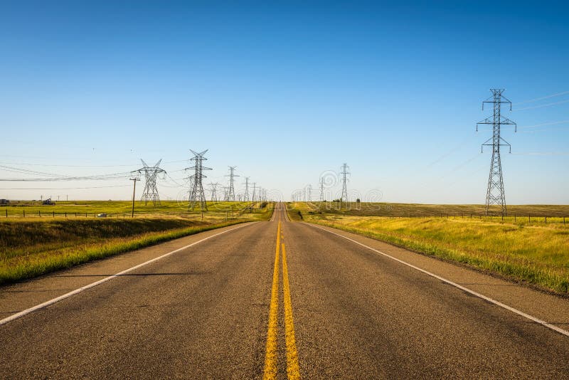 Electricity Pillars along an empty road in Alberta, Canada