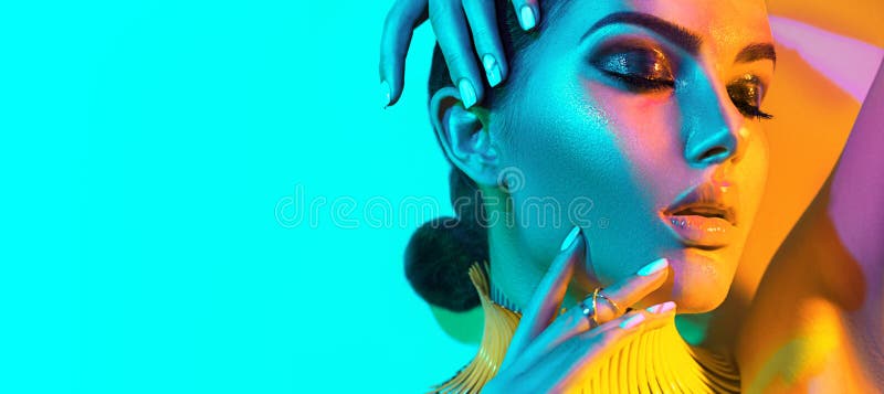 High Fashion model woman in colorful bright lights, portrait of beautiful sexy girl with trendy make-up and manicure