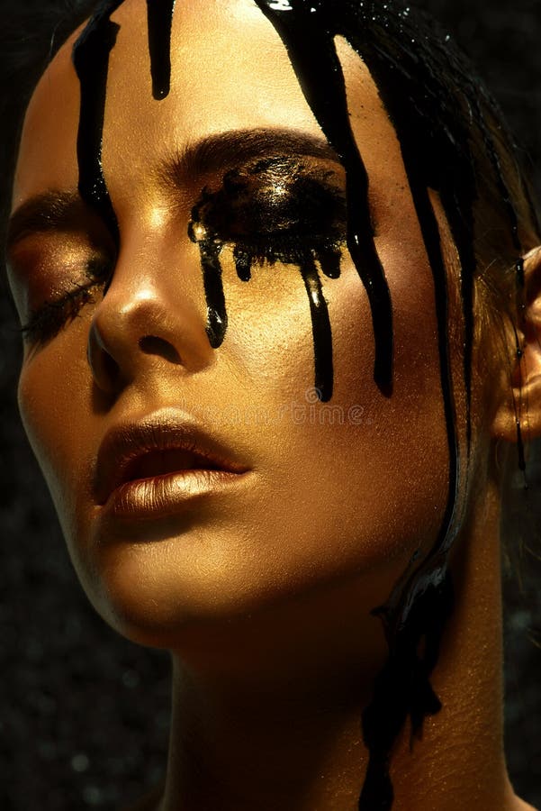 Beauty Provocation. Body Painting Project. Portrait Of A Young Woman With  Golden Skin And Black Oil Pouring On Her. Fashionable Provocation.  Pollution And Poisoning Concept. Stock Photo, Picture and Royalty Free  Image.