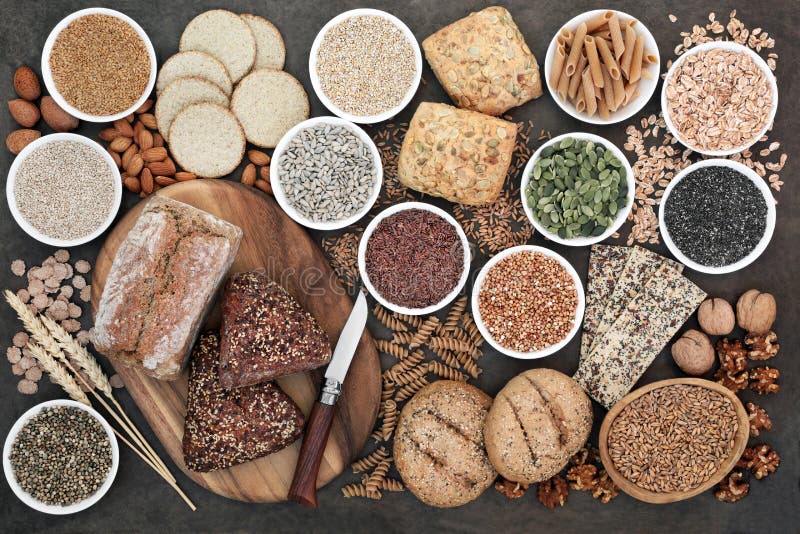 High fibre health food with whole grain bread and rolls, whole wheat pasta, grains, nuts, seeds, oatmeal, oats, crackers, barley royalty free stock image High fibre health food with whole grain bread and rolls, whole wheat pasta, grains, nuts, seeds, oatmeal, oats, crackers, barley royalty free stock image
