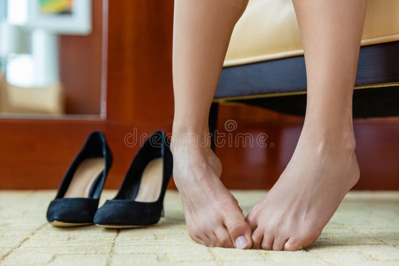 Female feet and heels, woman's lags get tied of shoes with high hill, woman  after party, closeup 17467206 Stock Photo at Vecteezy