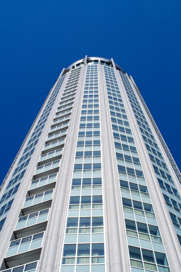 High modern building on background blue sky.