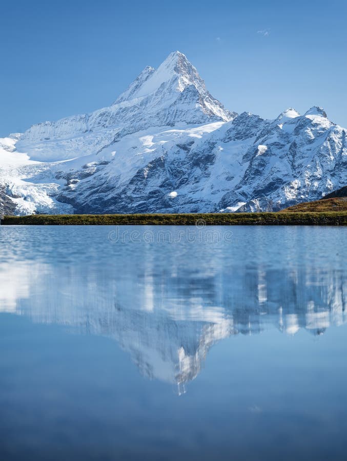 High Mountains and Reflection on the Surface of the Lake. the Forest ...