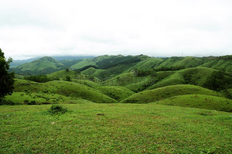 The high mountains tropical forest with clouds passing in India. stock photography
