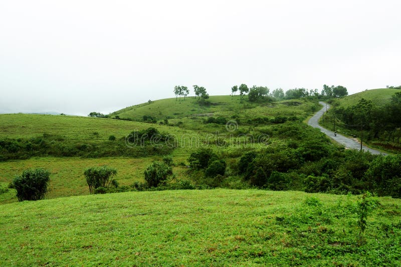 The high mountains tropical forest with clouds passing in India. stock photography