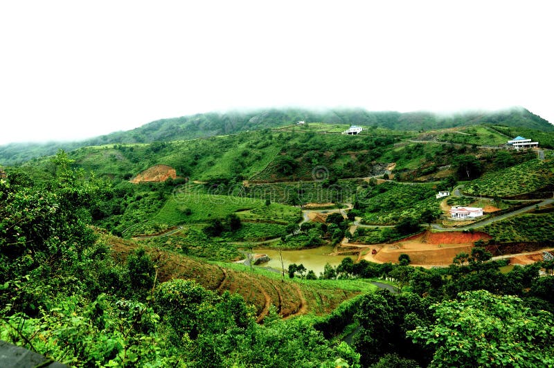 The high mountains tropical forest with clouds passing in India. stock image