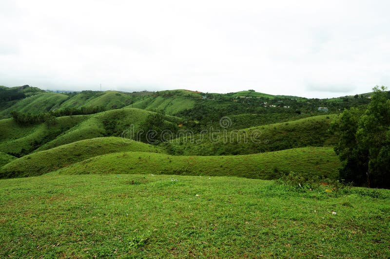 The high mountains tropical forest with clouds passing in India. royalty free stock image