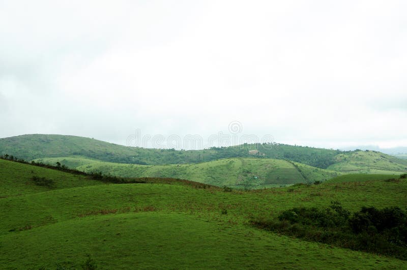 The high mountains tropical forest with clouds passing in India stock photo