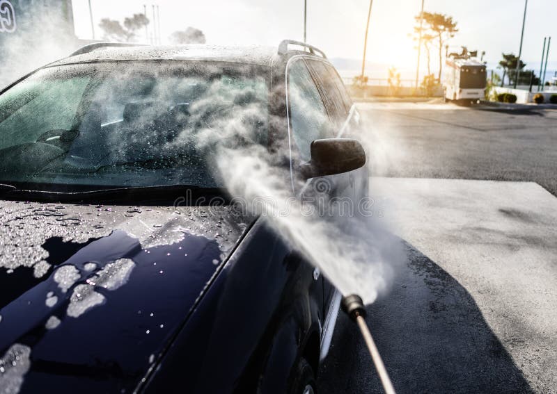 Highpressure Washing Car. Car Washing Under the Open Sky. Stock Photo
