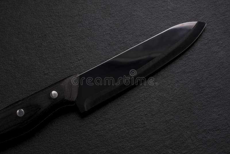Black ceramic knife on shale