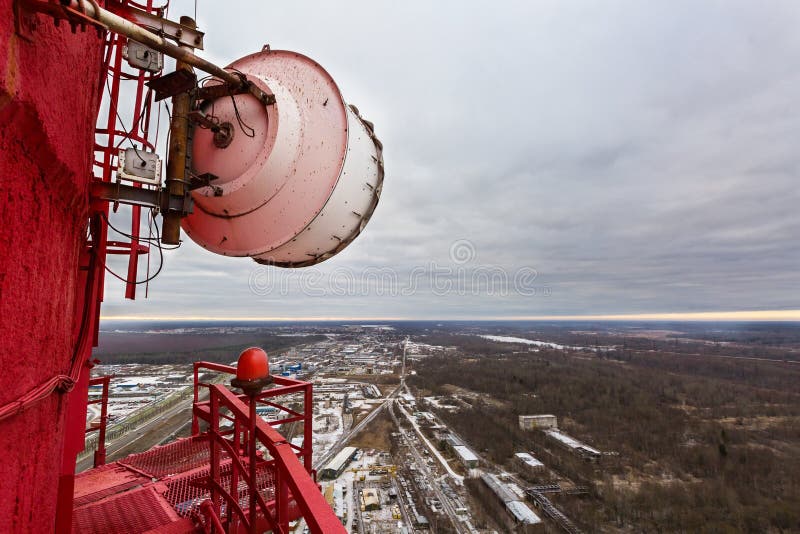 High red chimney of power plant with outdoor telecommunication high capacity microwave gear and huge radio antenna in cloudy day. royalty free stock images High red chimney of power plant with outdoor telecommunication high capacity microwave gear and huge radio antenna in cloudy day. royalty free stock images
