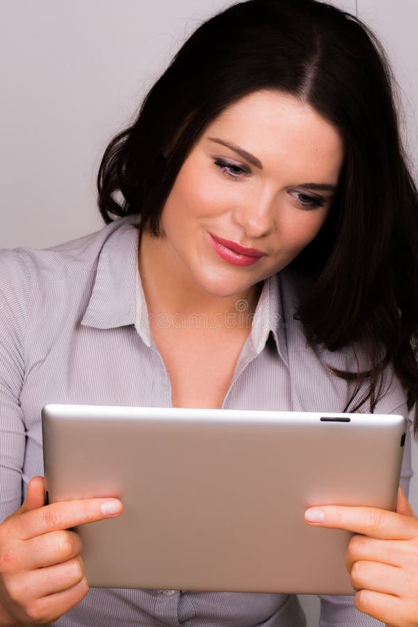 Beautiful young female using an ipad tablet device