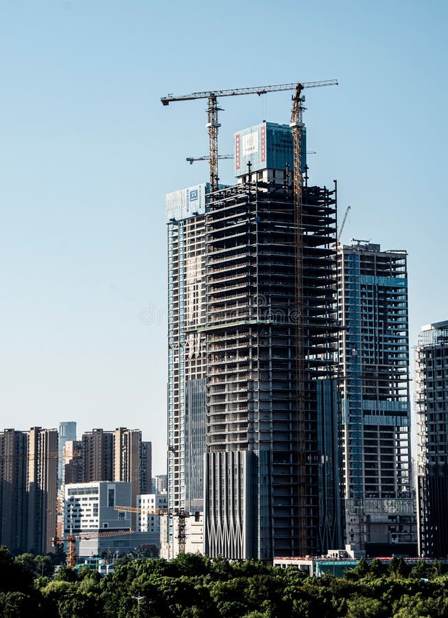 High-rise building under construction in an urban cityscape. royalty free stock photography