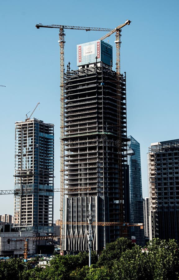 High-rise buildings under construction with cranes stock photos