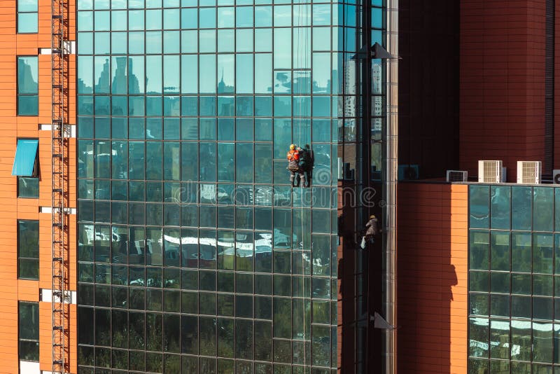 Highrise Workers Cleaning the Windows of a Skyscraper Stock Image