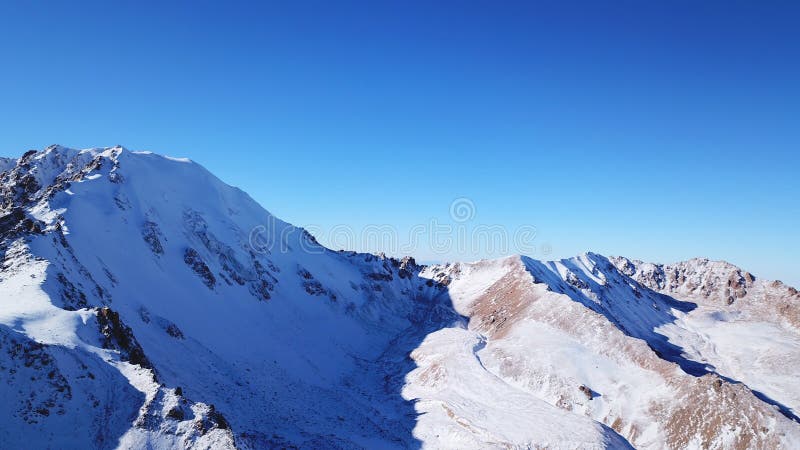 High rocks covered with snow. The Tuyuk Su Glacier