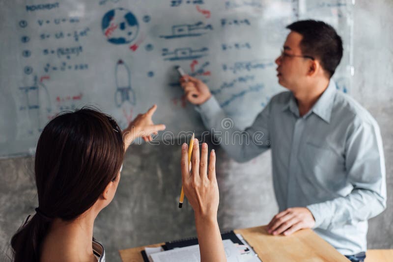 High school or college student group catching up workbook and learning tutoring in classroom and reading, doing homework and royalty free stock images High school or college student group catching up workbook and learning tutoring in classroom and reading, doing homework and royalty free stock images