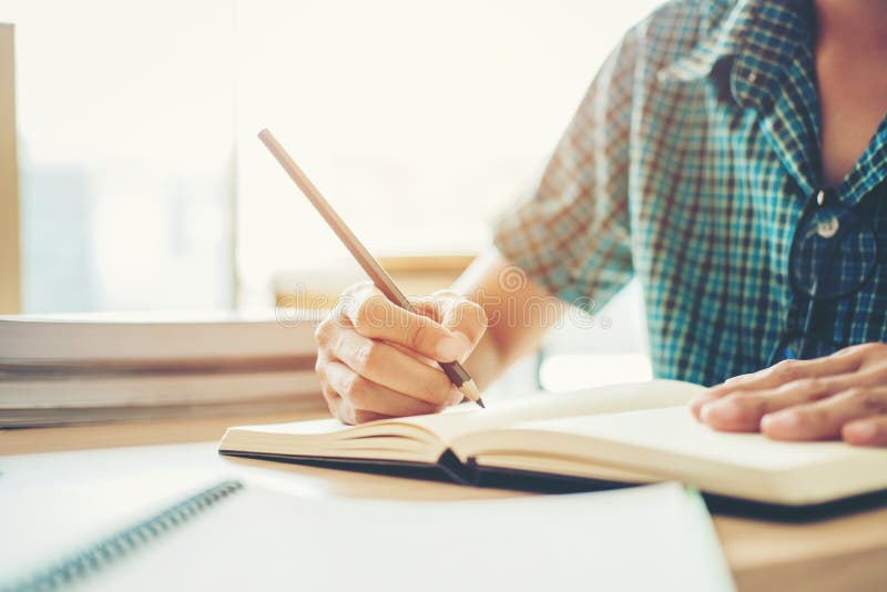 High school or college student studying and reading in library royalty free stock images High school or college student studying and reading in library royalty free stock images