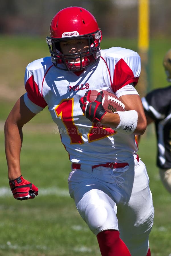 High School Football Player Running with the Ball