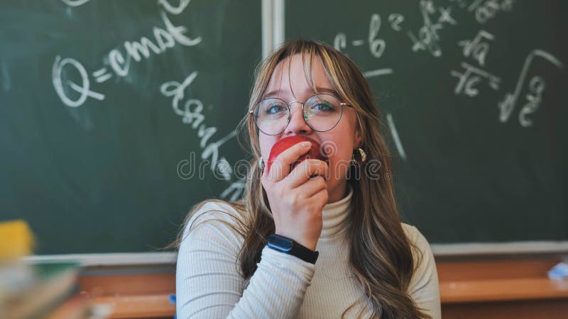 A high school girl eating an apple. stock image