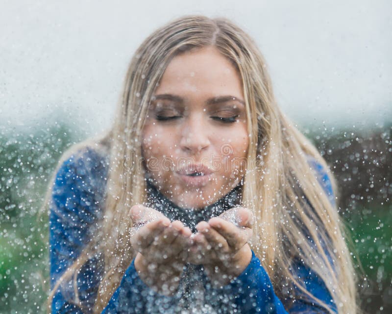 High School Senior Poses for Portraits Blowing Glitter Stock Photo ...